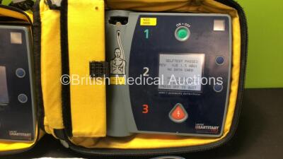2 x Laerdal Heartstart FR2 Defibrillators in Carry Bags with 3 x Philips M3863A Batteries and 5 x Electrode Packs *3 x Expired* (Both Power Up and Pass Self Tests) **SN 1002073519 / 1002073515** - 3