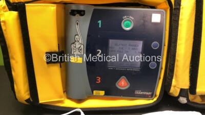 2 x Laerdal Heartstart FR2 Defibrillators in Carry Bags with 3 x Philips M3863A Batteries and 5 x Electrode Packs *3 x Expired* (Both Power Up and Pass Self Tests) **SN 1002073519 / 1002073515** - 5