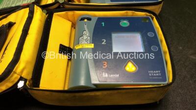 2 x Laerdal Heartstart FR2+ Defibrillators with 2 x Philips M3863A Batteries *Install Dates 03-2019, 11-2021* In 2 x Carry Bags (Both Power Up and Pass Self Tests) *SN 0706199858, 0706199890* - 2