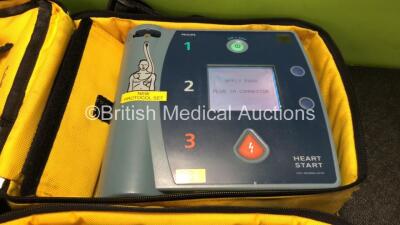 2 x Philips Heartstart FR2+ Defibrillators with 2 x Philips M3863A Batteries *Install Dates 02-2022, 08-2020* In 2 x Carry Bags (Both Power Up and Pass Self Tests) *SN 0606196204, 0610990082 - 3