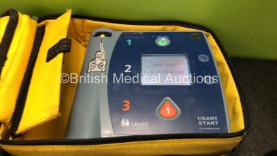 2 x Laerdal Heartstart FR2+ Defibrillators with 2 x Philips M3863A Batteries *Install Dates 11-2023, 07-2024* 2 x Defibrillator Electrodes *Both In Date* In 2 x Carry Bags (Both Power Up and Pass Self Tests) *SN 0510801551, 1007258821* - 3