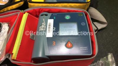 2 x Philips Heartstart FR2+ Defibrillators with 2 x Philips M3863A Batteries *Install Dates 05-2020, 01-2023 * 3 x Defibrillator Electrodes *All Out of Date* In 2 x Carry Bags (Both Power Up and Pass Self Tests) *SN 1110990372, 0905166713 - 2