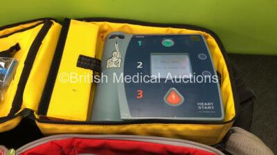 2 x Philips Heartstart FR2+ Defibrillators with 2 x Philips M3863A Batteries *Install Dates 05-2020, 01-2023 * 3 x Defibrillator Electrodes *All Out of Date* In 2 x Carry Bags (Both Power Up and Pass Self Tests) *SN 1110990372, 0905166713 - 3