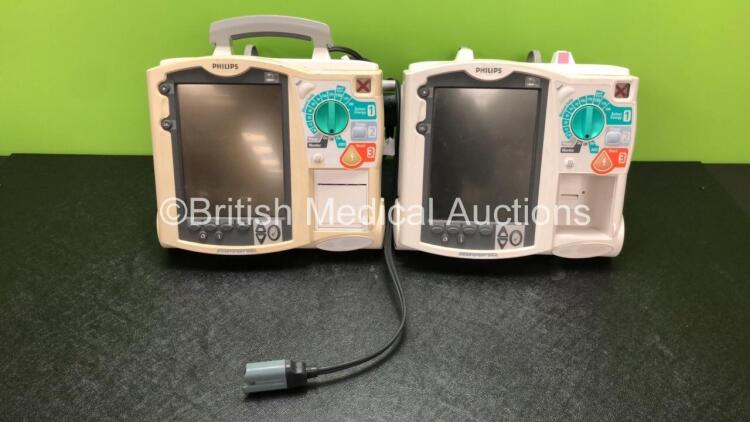 2 x Philips Heartstart MRx Defibrillators Including Pacer, ECG and Printer Options with 1 x Paddle Lead (Both Power Up with Stock Power Module, Module Not Included, 1 x Missing Printer, 1 x Missing Handle - See Photos)