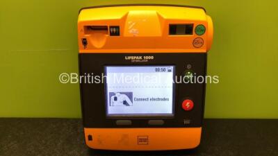 Physio Control Lifepak 1000 Defibrillator with 4 x Physio Control Ref 11141-000156 Batteries *1 x Good Battery, 3 x Flat Batteries* (Powers Up) - 3
