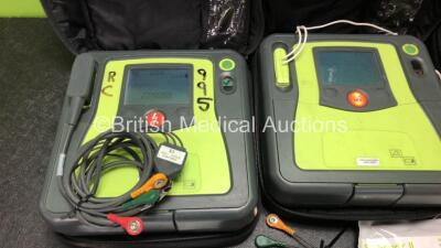 3 x Zoll AED PRO Defibrillators with 3 x Batteries with 3 x 3 Lead ECG Leads, 2 x Defibrillator Pads *Both Out of Date* In 3 x Carry Bags (All Power Up) *SN AA09C013183, AA05C000332, AA08009973* - 2