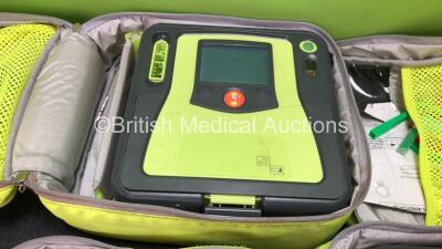 3 x Zoll AED PRO Defibrillators with 3 x Batteries with 2 x 3 Lead ECG Leads, 1 x Defibrillator Pads *Out of Date* In 3 x Carry Bags (All Power Up) *SN AA11A019611, AA10C016899, AA10C016810* - 2