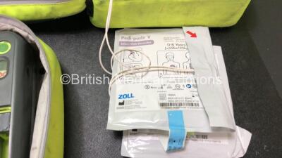 3 x Zoll AED PRO Defibrillators with 3 x Batteries with 2 x 3 Lead ECG Leads, 3 x Defibrillator Pads *All Out of Date* In 3 x Carry Bags (All Power Up) *SN AA10C016781, AA13C027734, AA11C020085* - 4