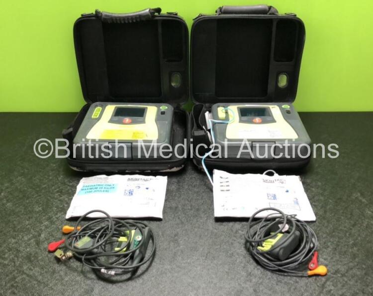 2 x Zoll AED PRO Defibrillators with 2 x 3 Lead ECG Leads, 2 x Electrode Packs *1 In Date, 1 Out of Date* in 2 x Carry Bags (Both Power Up with Stock Battery, Batteries Not Included, Slightly Damaged Display Screens)