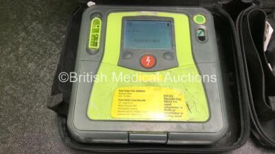 2 x Zoll AED PRO Defibrillators with 2 x 3 Lead ECG Leads, 2 x Electrode Packs *1 In Date, 1 Out of Date* in 2 x Carry Bags (Both Power Up with Stock Battery, Batteries Not Included, Slightly Damaged Display Screens) - 2