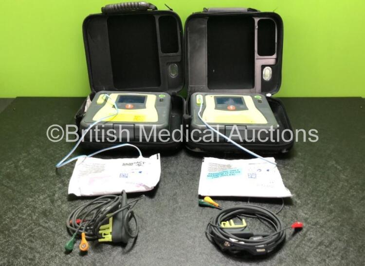 2 x Zoll AED PRO Defibrillators with 2 x 3 Lead ECG Leads, 2 x Electrode Packs *1 In Date, 1 Out of Date* in 2 x Carry Bags (Both Power Up with Stock Battery, Batteries Not Included, Slightly Damaged Display Screens)
