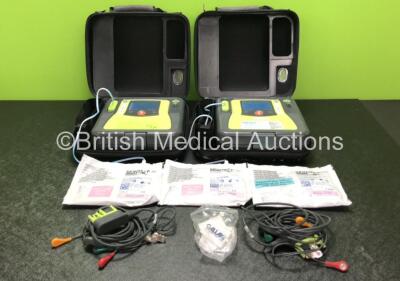 2 x Zoll AED PRO Defibrillators with 2 x 3 Lead ECG Leads, 3 x Electrode Packs *All Out of Date* in 2 x Carry Bags (Both Power Up with Stock Battery, Batteries Not Included, Slightly Damaged Display Screens)