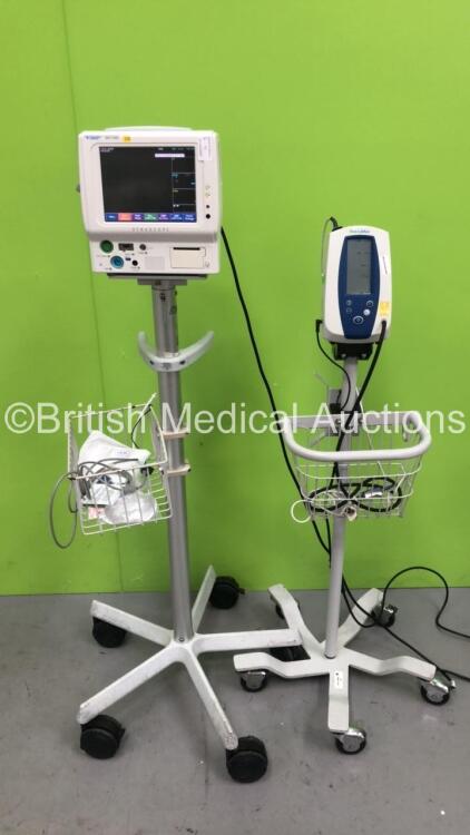 1 x Welch Allyn SPOT Vital Signs Monitor on Stand with BP Hose and SPO2 Finger Sensor and Fukuda Denshi DS-7100 Patient Monitor on Stand (Both Power Up)