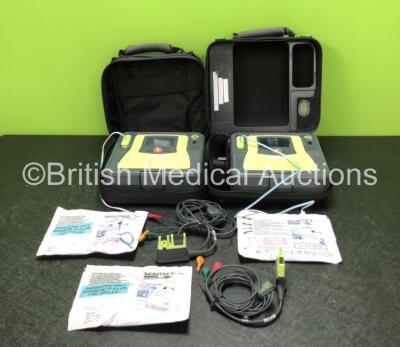 2 x Zoll AED PRO Defibrillators with 2 x 3 Lead ECG Leads, 3 x Electrode Packs *2 x in Date, 1 x Expired* and 2 x Batteries in 2 x Carry Bags (Both Power Up with Slight Damage to Screens and Cracks in Casing - See Photos)