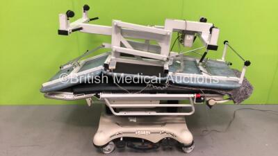 1 x Stryker Hydraulic Patient Transport Trolley with Mattress (Damage to Wheels - See Pictures) and 1 x Plinth 2000 Electric Patient Examination Couch with Controller (Powers Up) *S/N 503E5P360*