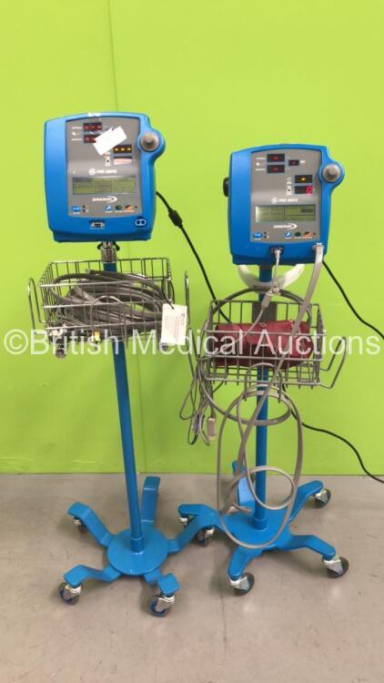 2 x Dinamap Pro 300V2 Vital Signs Monitors on Stands with SPO2 Finger Sensors and BP Hoses (Both Power Up)