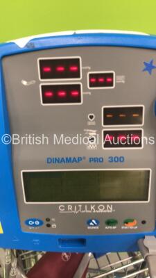 2 x GE Dinamap Pro 300V2 Vital Signs Monitor on Stands with SPO2 Finger Sensors and BP Hoses, 1 x GE Dinamap Pro 300V2 Vital Signs Monitor on Stand with SPO2 Finger Sensor and BP Hoses and 1 x GE Dinamap Critikon Pro 300 Vital Signs Monitor on Stand (All - 4