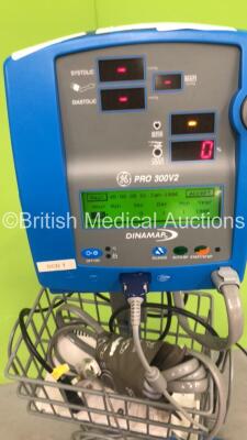 2 x GE Dinamap Pro 300V2 Vital Signs Monitor on Stands with SPO2 Finger Sensors and BP Hoses, 1 x GE Dinamap Pro 300V2 Vital Signs Monitor on Stand with SPO2 Finger Sensor and BP Hoses and 1 x GE Dinamap Critikon Pro 300 Vital Signs Monitor on Stand (All - 6