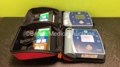 2 x Philips Heartstart FR2+ Defibrillators with 1 x Philips M3863A Battery in Carry Cases (Both Power Up and Pass Self Test) *SN 0307227202 / 0303086366*