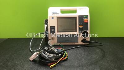 Medtronic Lifepak 12 Biphasic Defibrillator / Monitor Including ECG, NIBP, SpO2, CO2 and Printer Options with 1 x Paddle Lead, 1 x Physio Control 4 Lead ECG Lead and 1 x SpO2 Finger Sensor (Powers Up when Tested with Stock Battery-Batteries Not Included)