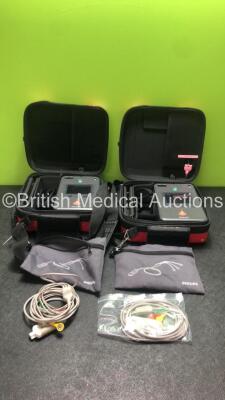 2 x Philips Heartstart FR3 Defibrillators with 2 x Batteries and 2 x 3 Lead ECG Leads in Carry Cases (Both Power Up) *SN C11K00561, C11K00570*