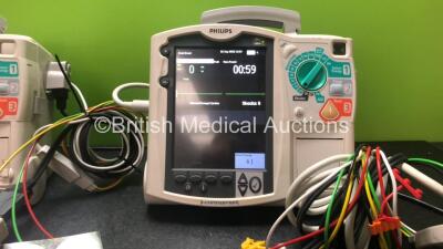 2 x Philips Heartstart MRx Defibrillators Including Pacer, ECG and Printer Options with 2 x Philips M3539A Modules, 2 x Philips M3538A Batteries, 2 x Paddle Leads, 2 x Philips M3725A 50 Ohm Test Loads and 2 x 3 Lead ECG Leads (Both Power Up) *SN US0031532 - 3