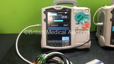 2 x Philips Heartstart MRx Defibrillators Including ECG and Printer Options with 2 x Philips M3539A Modules, 2 x Philips M3538A Batteries, 2 x Paddle Leads, 2 x Philips M3725A 50 Ohm Test Loads and 2 x 3 Lead ECG Leads (Both Power Up) *SNUS00315336, US003 - 2