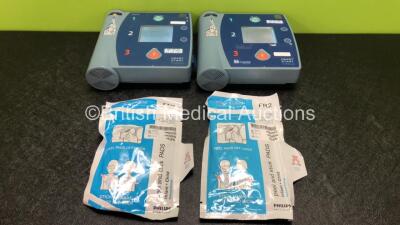 2 x Philips Heartstart FR2+ Defibrillators with 2 x Philips M3863A Batteries and 2 x Philips Infant Electrode Packs *Both in Date* (Both Power Up and Pass Self Test)