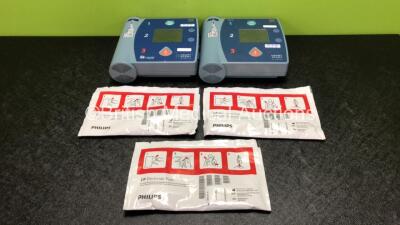 2 x Philips Heartstart FR2+ Defibrillators with 2 x Philips M3863A Batteries and 3 x Phillips DP Electrode Packs *All Expired* (Both Power Up and Pass Self Test)