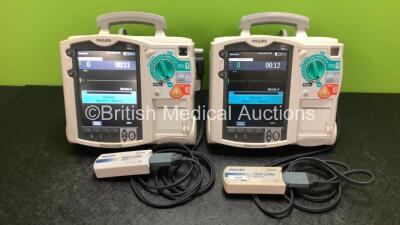 2 x Philips Heartstart MRx Defibrillators Including ECG and Printer Options with 2 x Philips M3539A Modules, 2 x Philips M3538A Batteries, 2 x Paddle Leads and 2 x Philips M3725A 50 Ohm Test Loads (Both Power Up) *SN US00539109 / US00315375*