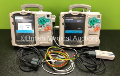 2 x Philips Heartstart MRx Defibrillators Including ECG, Pacer and Printer Options with 2 x Philips M3539A Modules, 2 x Philips M3538A Batteries, 2 x Paddle Leads, 1 x Philips M3725A 50 Ohm Test Load and 1 x 3 Lead ECG Lead (Both Power Up) *SN US00315247 