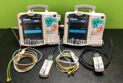 2 x Philips Heartstart MRx Defibrillators Including ECG and Printer Options with 2 x Philips M3539A Modules, 2 x Philips M3538A Batteries, 2 x Paddle Leads, 2 x Philips M3725A 50 Ohm Test Loads and 2 x 3 Lead ECG Leads (Both Power Up) *SN US00315323 / US0