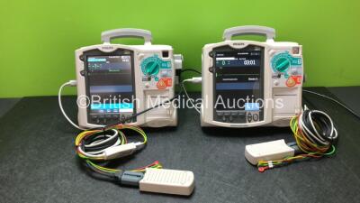 2 x Philips Heartstart MRx Defibrillators Including Pacer, ECG and Printer Options with 2 x Philips M3539A Modules, 2 x Philips M3538A Batteries, 2 x Paddle Leads, 1 x Philips M3725A 50 Ohm Test Load and 1 x 3 Lead ECG Lead (Both Power Up, 1 with Damaged 