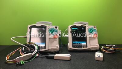 2 x Philips Heartstart MRx Defibrillators Including Pacer, ECG and Printer Options with 2 x Philips M3539A Modules, 2 x Philips M3538A Batteries, 2 x Paddle Leads, 1 x Philips M3725A 50 Ohm Test Load and 2 x 3 Lead ECG Lead (Both Power Up, 1 with Damaged 