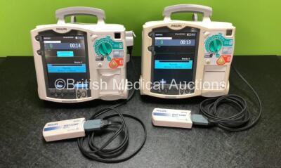 2 x Philips Heartstart MRx Defibrillators Including Pacer, ECG and Printer Options with 2 x Philips M3539A Modules, 2 x Philips M3538A Batteries, 2 x Paddle Leads and 2 x Philips M3725A 50 Ohm Test Loads (Both Power Up) *SN US00315384 / US00315394*