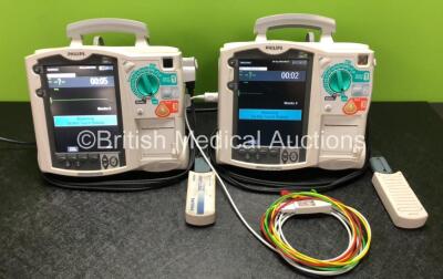 2 x Philips Heartstart MRx Defibrillators Including ECG and Printer Options with 2 x Philips M3539A Modules, 1 x Philips M3538A Battery, 2 x Paddle Leads, 2 x Philips M3725A 50 Ohm Test Loads and 2 x 3 Lead ECG Leads (Both Power Up) *SN US00554870 / US003