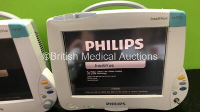 2 x Philips IntelliVue MP50 Patient Monitors (Both Power Up, 1 x Missing Dial and Damage to Casing / Module Clip - See Photos) with 1 x Philips M3015A Module Including Press, Temp and CO2 Microstream Options (Damaged Connection - See Photos) - 3