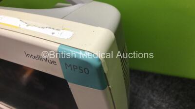 2 x Philips IntelliVue MP50 Patient Monitors (Both Power Up, 1 x Missing Dial and Damage to Casing / Module Clip - See Photos) with 1 x Philips M3015A Module Including Press, Temp and CO2 Microstream Options (Damaged Connection - See Photos) - 6