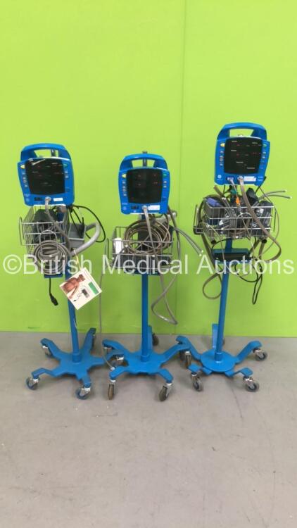 2 x GE Dinamap ProCare Auscultatory 300 Vital Signs Monitor on Stand ad 1 x GE Procare Auscultatory Vital Signs Monitor on Stand (All Power Up) *S/N 2019194-001*