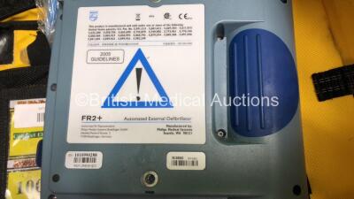 2 x Laerdal Heartstart FR2 Defibrillators and 1 x Philips FR2+ Heartstart Defibrillator with 3 x Batteries and 6 x Skintact Electrodes in Carry Bags (All Power Up and Pass Self Test) *SN 1010990288,0600006373,0900012338* - 6