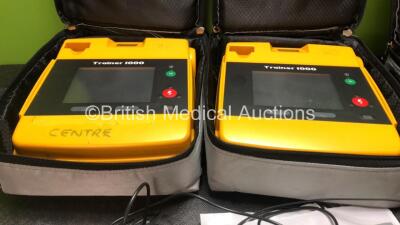 3 x Trainer 1000 Defibrillators with 2 x Power Supplies and 1 x Electrode (2 x Power Up, 1 x No Power) - 2