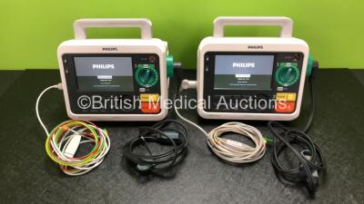 2 x Philips Efficia DFM100 Defibrillators *Mfd - 2019 / 2019* with ECG and Printer Options Including 2 x 3 Lead ECG Leads, 2 x Paddle Leads and 2 x Philips Rechargeable Li-ion Battery Packs (Both Power Up)