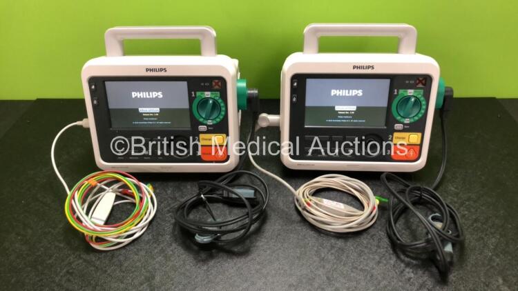 2 x Philips Efficia DFM100 Defibrillators *Mfd - 2019 / 2019* with ECG and Printer Options Including 2 x 3 Lead ECG Leads, 2 x Paddle Leads and 2 x Philips Rechargeable Li-ion Battery Packs (Both Power Up)