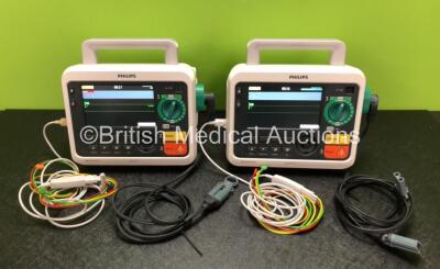 2 x Philips Efficia DFM100 Defibrillators *Mfd - 2019 / 2019* with ECG and Printer Options Including 2 x 3 Lead ECG Leads, 2 x Paddle Leads and 2 x Philips Rechargeable Li-ion Battery Packs (Both Power Up)