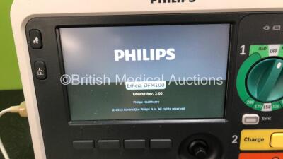 2 x Philips Efficia DFM100 Defibrillators *Mfd - 2019 / 2019* with ECG and Printer Options Including 2 x 3 Lead ECG Leads, 2 x Paddle Leads and 2 x Philips Rechargeable Li-ion Battery Packs (Both Power Up) - 5