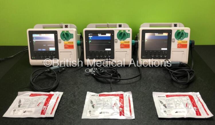 3 x Philips Heartstart XL+ Defibrillators Including ECG and Printer Options with 3 x Paddle Leads, 3 x Philips Multifunction Electrode Pads *All in Date* and 3 x Batteries (All Power Up)