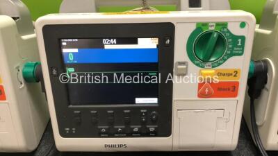 3 x Philips Heartstart XL+ Defibrillators Including ECG and Printer Options with 3 x Paddle Leads, 3 x Philips Multifunction Electrode Pads *All in Date* and 3 x Batteries (All Power Up) - 3