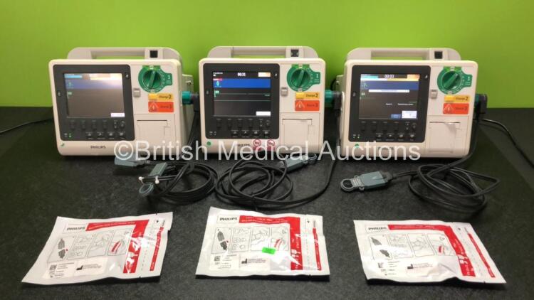 3 x Philips Heartstart XL+ Defibrillators Including ECG and Printer Options with 3 x Paddle Leads, 3 x Philips Multifunction Electrode Pads *2 Expired, 1 in Date* and 3 x Batteries (All Power Up)