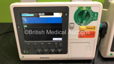 3 x Philips Heartstart XL+ Defibrillators Including ECG and Printer Options with 3 x Paddle Leads, 3 x Philips Multifunction Electrode Pads *2 Expired, 1 in Date* and 3 x Batteries (All Power Up) - 2