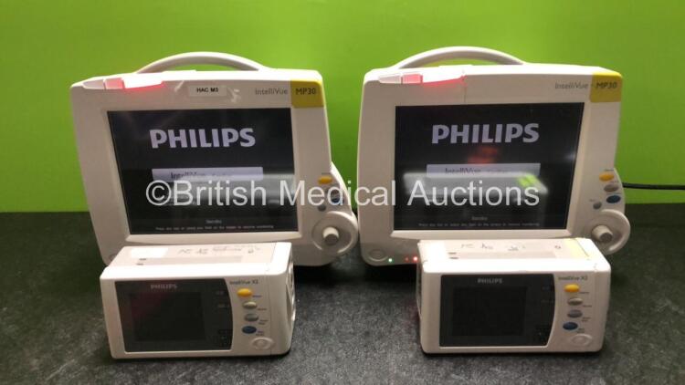 2 x Philips IntelliVue MP30 Patient Monitors (Both Power Up with Damage to Casing - See Photos) with 2 x Philips IntelliVue X2 Handheld Patient Monitors Including Press, Temp, NBP, SpO2 and ECG/Resp Options with 2 x Batteries (Both Power Up, 1 x Damaged C